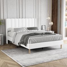 a white bed sitting on top of a wooden floor