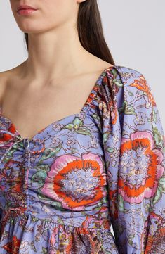 A scrunched-and-tied front gives shape to this flowery top designed with billowed sleeves and a flouncy peplum. 20 1/2" length (size medium) Sweetheart neck Three-quarter sleeves 100% organic cotton Dry clean Imported Multicolor Tops With Gathered Sleeves For Spring, Spring Ruched Viscose Tops, Flowy Ruched Blouse For Spring, Summer Floral Print Peasant Top With Balloon Sleeves, Floral Print Cropped Blouse For Brunch, Spring Viscose Top With Gathered Sleeves, Floral Print Puff Sleeve Peasant Top For Brunch, Spring Vacation Ruched Blouse, Flowy Floral Print Top With Balloon Sleeves