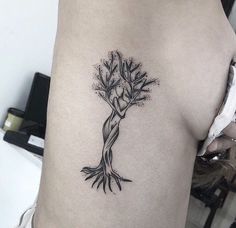 a woman with a tree tattoo on her back