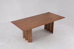 a wooden table sitting on top of a white floor