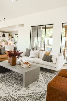 a living room filled with furniture and lots of windows