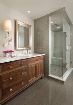 a bathroom with two sinks and a walk in shower