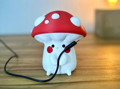 a mushroom shaped light is plugged into a charger