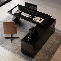 an office desk with a chair and computer on it in the middle of a room