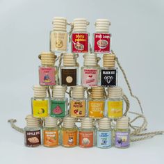 an assortment of small bottles are stacked on top of each other with strings attached to them