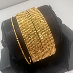 "* Handcrafted Gold Plated Bangle Set * High Quality 22 K Gold Plated 24 pc. Bangle set * Size: 2.2 has 2.2\" inner circle diameter ; 2.4 ( 2.31\" inner circle diameter) ; 2.6 ( 2.46\" inner circle diameter); 2.8 (2.64\" inner circle diameter) * Sold as a set of 24 bangles A gorgeous gold-plated bangle/ bracelet best exemplifies the careful craftsmanship done on it -- a specialty at Nemali Jewelry. It has a special tone of elegance attached to it. The intricate handmade design of the bangle / br Handmade Gold Bangles, Bangle Set Gold, Indian Bangles Gold, Gold Bangles Design Indian, Luxury Round Bangle For Wedding, Gold Bangles Set, Gold Bangles Set Of 6, Traditional Gold Bracelets For Festive Season, Gold Bracelets For Festive Occasions