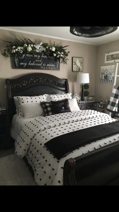 a black and white bed in a room with pictures on the wall above it that says sandy's post