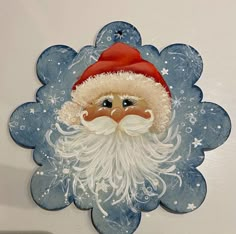 a blue and white plate with a santa claus face on it's center piece