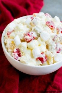 a white bowl filled with food on top of a red cloth