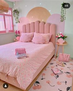 a bed with pink sheets and pillows in a room