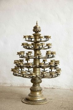 a gold christmas tree made out of old brass plates