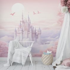 a baby's room decorated in pink and white with a castle mural on the wall