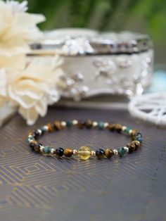 Mix Gemstone Elastic Bracelet Bracelet Specifications: - Handmade by Ethereal Gems Jewellery - Natural 4mm Tiger's Eye & Emerald & Citrine Gemstones - Metal: 14k Gold Filled or 925 Sterling Silver  - Comes with a gift box  - Bracelet Size: 16.5cm (6.5inch), 18.5cm (7.2inch), 20.5cm (8.07inch) M O R E * F R O M * U S https://www.etherealgemsjewellery.com https://www.etsy.com/uk/shop/EtherealGemsJewelry Please be advised that the photographs displayed may vary slightly from the actual product due 14k Gold-filled Faceted Bead Bracelets As Gifts, Everyday 14k Gold-filled Bracelets With Gemstone Beads, Adjustable 14k Gold-filled Bracelets With Faceted Beads, Green Onyx Bracelets - Gift, Gold Labradorite Beaded Bracelet, Spiritual Style, Photograph Display, Oval Stud Earrings, Citrine Gemstone, Elastic Bracelet