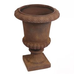 a brown vase sitting on top of a wooden stand