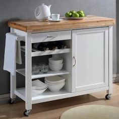 a kitchen cart with two bowls and plates on it, sitting in front of a wall