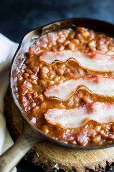 baked beans and bacon cooking in a skillet