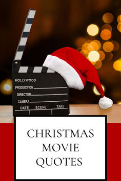 a christmas movie quote with a santa hat and film clapper on the table next to it