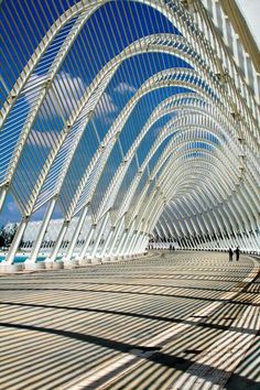 the inside of a building that is made out of wood and metal with blue skies in the background