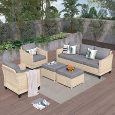 an outdoor living room with wicker furniture