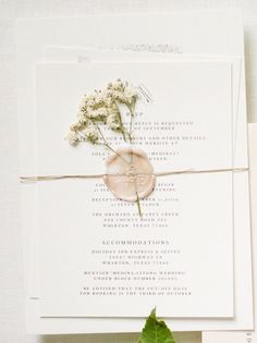 the wedding stationery is laid out on top of each other