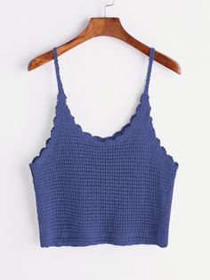 a blue crop top hanging on a wooden hanger