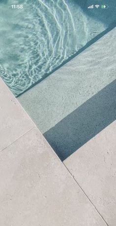 a skateboarder is sitting on the edge of a swimming pool