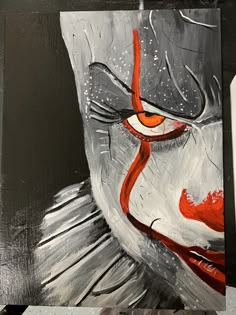 a painting of a clown's face with red eyes