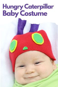 a baby wearing a red and green hat with big ears on it's head