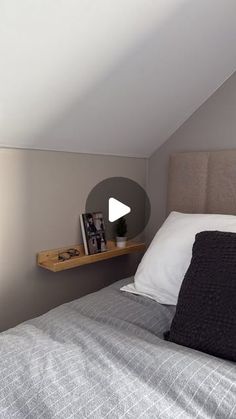 there is a bed in the room with a book shelf on the wall next to it