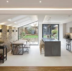 an open concept kitchen and dining area in a modern home with large sliding glass doors