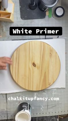 a wooden cutting board sitting on top of a white counter next to a knife holder