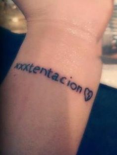 a woman's wrist tattoo with the word exxtentation on it