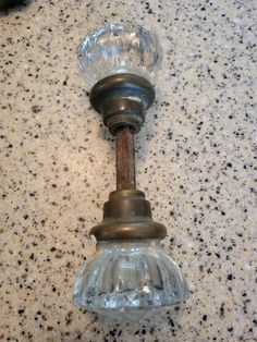 an old fashioned glass light fixture on a granite counter top