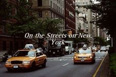 taxi cabs driving down the street in new york city, with words on it