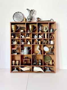 a wooden shelf filled with lots of different types of items on top of each other