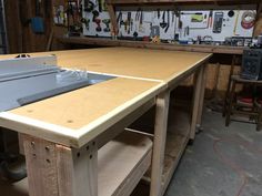 a workbench in a garage with tools hanging on the wall