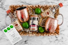 a basket filled with lots of different types of drinks and condiments on top of a table