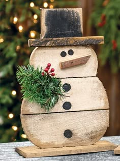 a snowman made out of wood sitting on top of a table