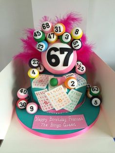 a birthday cake made to look like a number seventy with lots of balls on it