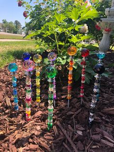 there are many different colored glass beads in the garden