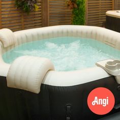 an inflatable hot tub sitting on top of a wooden deck