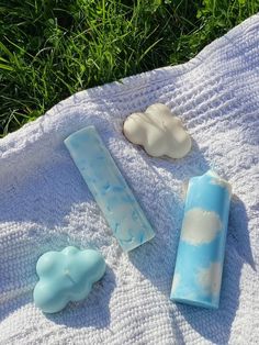 three soap bars sitting on top of a towel next to each other in the grass