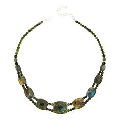 Jay King Nephrite Jade and Labradorite Reversible Necklace Gorgeous green nephrite jade and lovely labradorite together create a fun styling option with two unique looks in one versatile design. Simply reverse the necklace to change up your look! From Jay King.       Approx. 18"L x 15/16"W with 2-3/4" extender     Stamped .925     Hook closure     Dark green nephrite jade necklace has nine double-sided, barrel-shaped, faceted stations along drape     Each station has multicolor labradorite on on Green Chrysocolla Gemstone Beads Jewelry, Green Gemstone Jewelry With Labradorite, Spiritual Green Labradorite Necklaces, Spiritual Green Labradorite Necklace, Green Labradorite Necklaces With Natural Stones, Unique Looks, Necklace Stone, Single Bead, Nephrite Jade