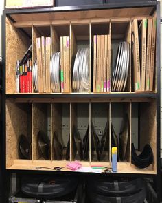 a wooden shelf filled with lots of different types of wires and plywood boxes on top of it