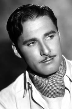 a black and white photo of a man wearing a tie