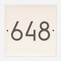 a white sign with black numbers on the front and back of it that says 648