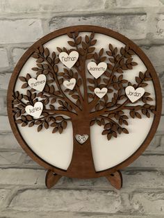 a wooden tree with hearts on it and the names of two people in each heart