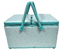 a blue and white box with flowers on it's sides, sitting in front of a white background