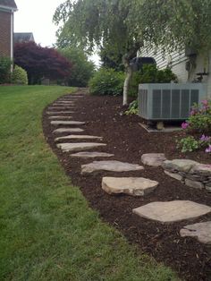 a stone path in front of a house