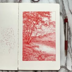 an open notebook with red ink on it next to a fountain pen and drawing supplies